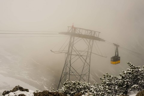 Cable car technicians working in bad weather conditions, Nebelhorn cable car near Oberstdorf,