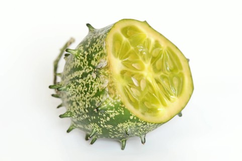 African horned melon (Cucumis metuliferus), sliced fruit on a white background