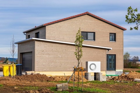 New build modern detached house with timber facade and heat pump, energy-saving house, efficiency