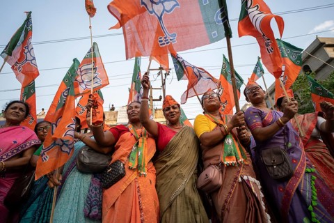 Bharatiya Janata Party (BJP) supporters dancing as they arrives to to see a roadshow of Union Home