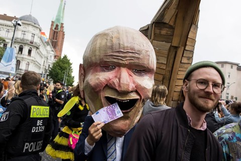 Dancer dressed as an investor from the 100% Tempelhofer Feld group at the street parade of the 26th