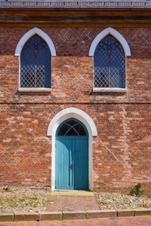Arched windows and door to St Laurentius Church in Toenning, North Friesland district,
