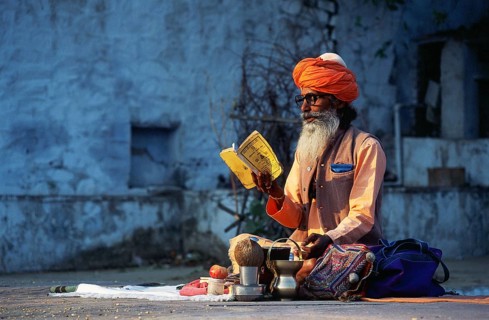 Hindu ascetic reading hindu scriptures, sadhu at pushkar, Rajasthan, India, Asia