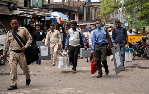 Barpeta, India. 6 May 2024. Polling officials carries Electronic Voting Machines (EVMs) and Voter