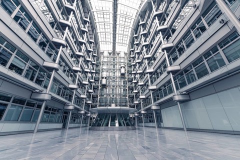 Wide-angle shot of a modern office building with glass facades and symmetrical structure, Berlin,