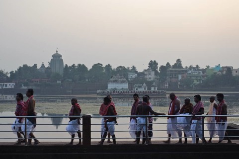 High caste hindus are walking along the lake Bindu, brahmins have performed a hindu ritual,