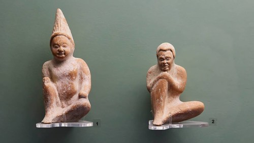 Figure number 1: Squatting boy in polos, number 2: squatting African boy, Two antique terracotta