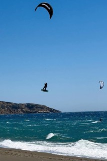 Kitesurfer Kitesurfer takes off in strong wind and waves rough sea moving sea flies with inflated