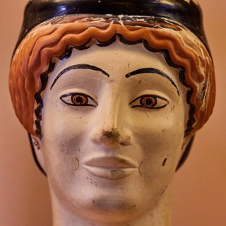 Attic vase in the shape of a woman's head, Midas, A painted ceramic face sculpture with vivid
