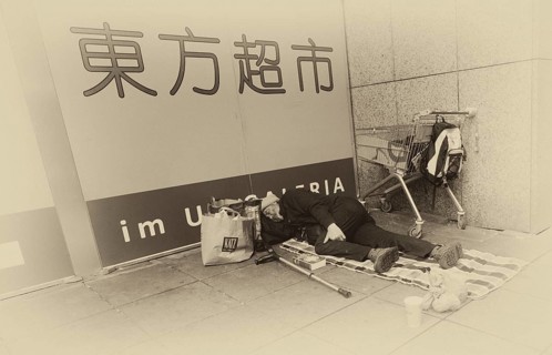 Homeless, Berber, sleeping, lying on pavement, Bible, shopping trolley, belongings, bag, Chinese