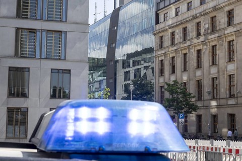 Blue light of a police vehicle in front of the German Bundestag with the Jakob Kaiser House in the