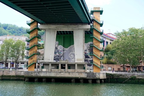 La Salve Bridge, A bridge with artistic graffiti on concreted pillars over a river Nervion, in the