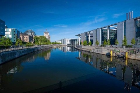 Reichstag, Paul-Loebe-Haus and Marie-Elisabeth-Lueders-Haus reflected in the Spree at sunrise,