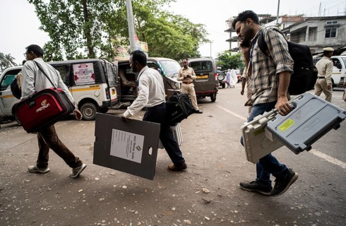 Barpeta, India. 6 May 2024. Polling officials carries Electronic Voting Machines (EVMs) and Voter