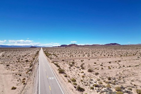 Drone shot of Route 66 with Route 66 sign on the road, Mojave Desert, California