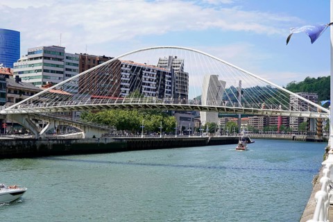 Pedestrian bridge Zubizuri, White bridge, Bilbao, Modern bridge over a river Nervion, with