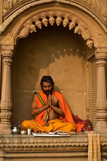 Hindu man worshipping the sun god Surya, Varanasi, India, Asia