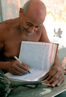 Jain monk writing his thoughts on his personal book, naked monk from the digambar sect, Rajasthan,
