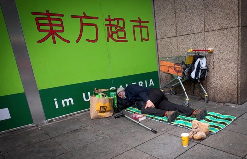 Homeless, Berber, sleeping, lying on pavement, Bible, shopping trolley, belongings, bag, Chinese