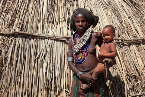 South Ethiopia, in a village of the Arbore or Erbore people at Lake Stefano, young woman with baby