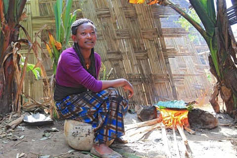 South Ethiopia, among the Dorze people, woman bakes flatbread, the mass of the ground false banana