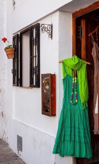 Green dress at the entrance to a fashion shop, Vejer, Andalusia, Spain, Europe
