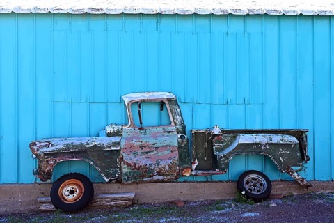 Side view of an antique pick-up truck hanging cut open on the wall, Route 66, Seligman, Arizona
