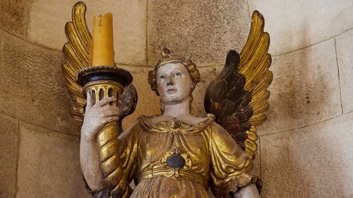 Golden angel sculpture with candle in historical ambience, interior view, Grand Master's Palace,