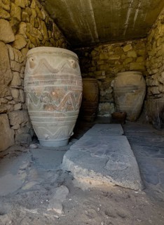 View into historical pantry protected with modern concrete cladding with large decorated clay