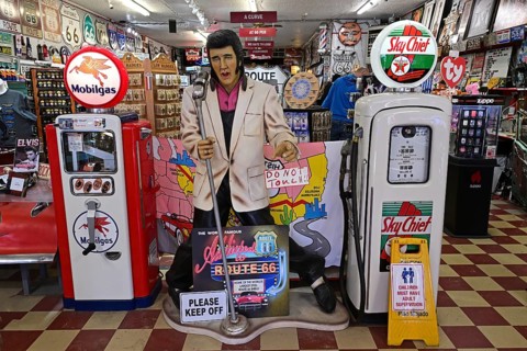 Elvis between historic petrol pumps in a souvenir shop, Williams, Arizona