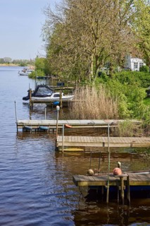 Jetties for pleasure craft on the Westersielzug with the Treene in the background in