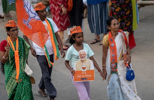 Bharatiya Janata Party (BJP) supporters arrives to to see a roadshow of Union Home minister Amit