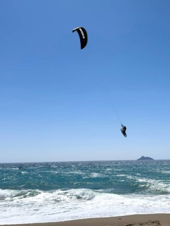 Kitesurfer Kitesurfer takes off in strong wind and waves rough sea moving sea flies with inflated