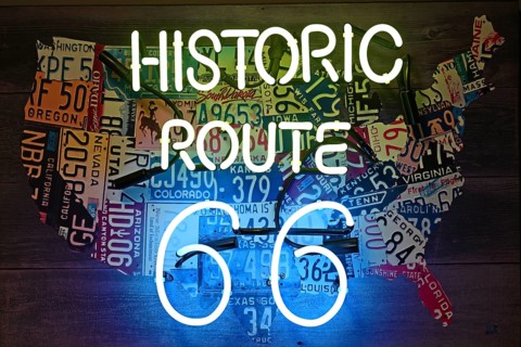 Neon sign with inscription Historic Route 66 in front of USA map