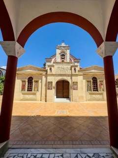View through archway to main entrance portal of orthodox church monastery church Zoodochos Pege in