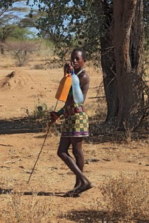 South Ethiopia, Omo region, man from the Karo people with water bottles, plastic bottles filled
