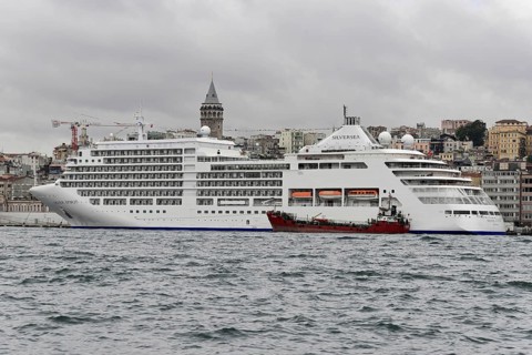 Cruise ship SILVERSEA, against the backdrop of Istanbul and the Galata Tower on a cloudy day,