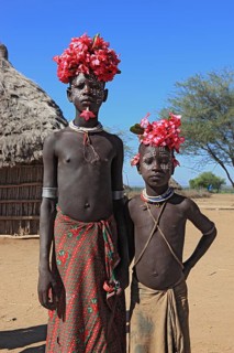 South Ethiopia, Omo region, tribal members of the Karo people, with floral decorations and body