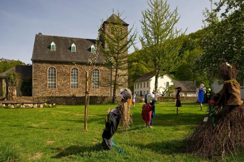 Scarecrows at the Protestant church in Unterburg, Solingen, Bergisches Land, North Rhine-Westphalia