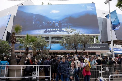 Cannes, France, 14 May 2024: Guests in front of the poster at the opening of the 77th Cannes