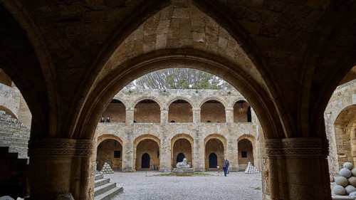 Architecture of a historic courtyard with Gothic arcades, indicates medieval construction, outdoor