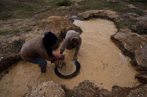 Woman and teenage girl looking for gold. Near Ambositra, Madagascar. Both belong to the Betsileo