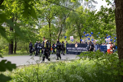 Participants with banner Water. Forest. Justice. For a traffic turnaround beyond Tesla and balloons