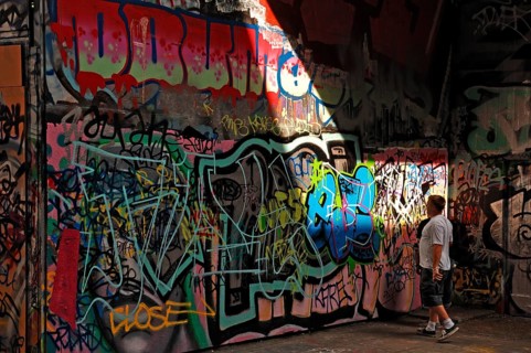 Graffiti artist at work in a skateboard park on the Thames, London, England, Great Britain