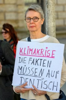 Participant in a silent protest for the hunger strikers. The poster reads: Climate crisis, the
