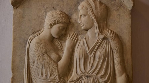 Krito and Timarista, close-up of an ancient bas-relief, two woman in classical dress, intimate