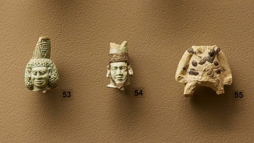 Eastern Greek or Rhodian workshop, Three ancient stone masks in detail view on a wall, interiors,
