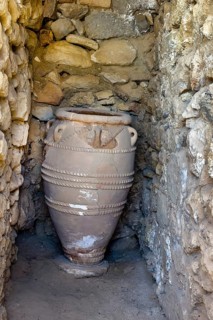 View into historical storeroom below present floor level with large decorated clay vessel Pithoi in