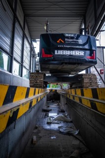 An excavator stands on a lifting platform inside a building, demolition, Saarbruecken, Germany,