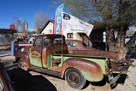 Old, rusty cars in the backyard of Delgadillo's Snow Cap Drive Inn on Route 66, Seligman, Arizona
